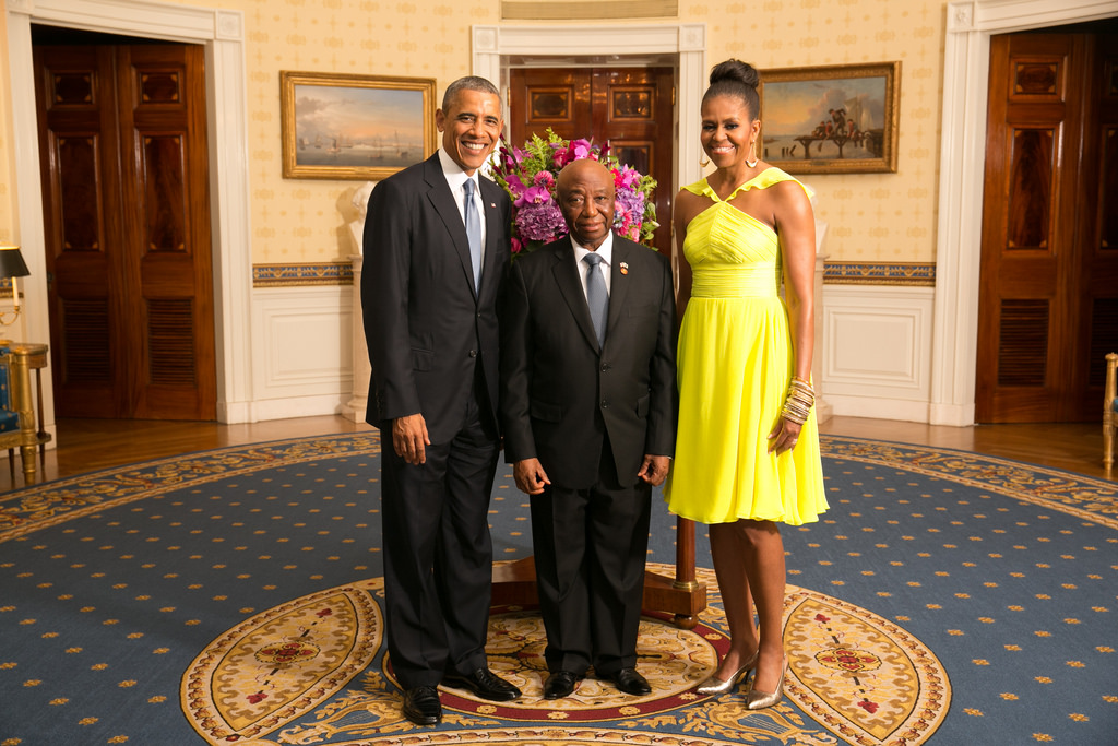 Vice President Joseph Boakai (center) poses with U.S. President Barack Obama (left) and Mrs. Michelle Obama (right)